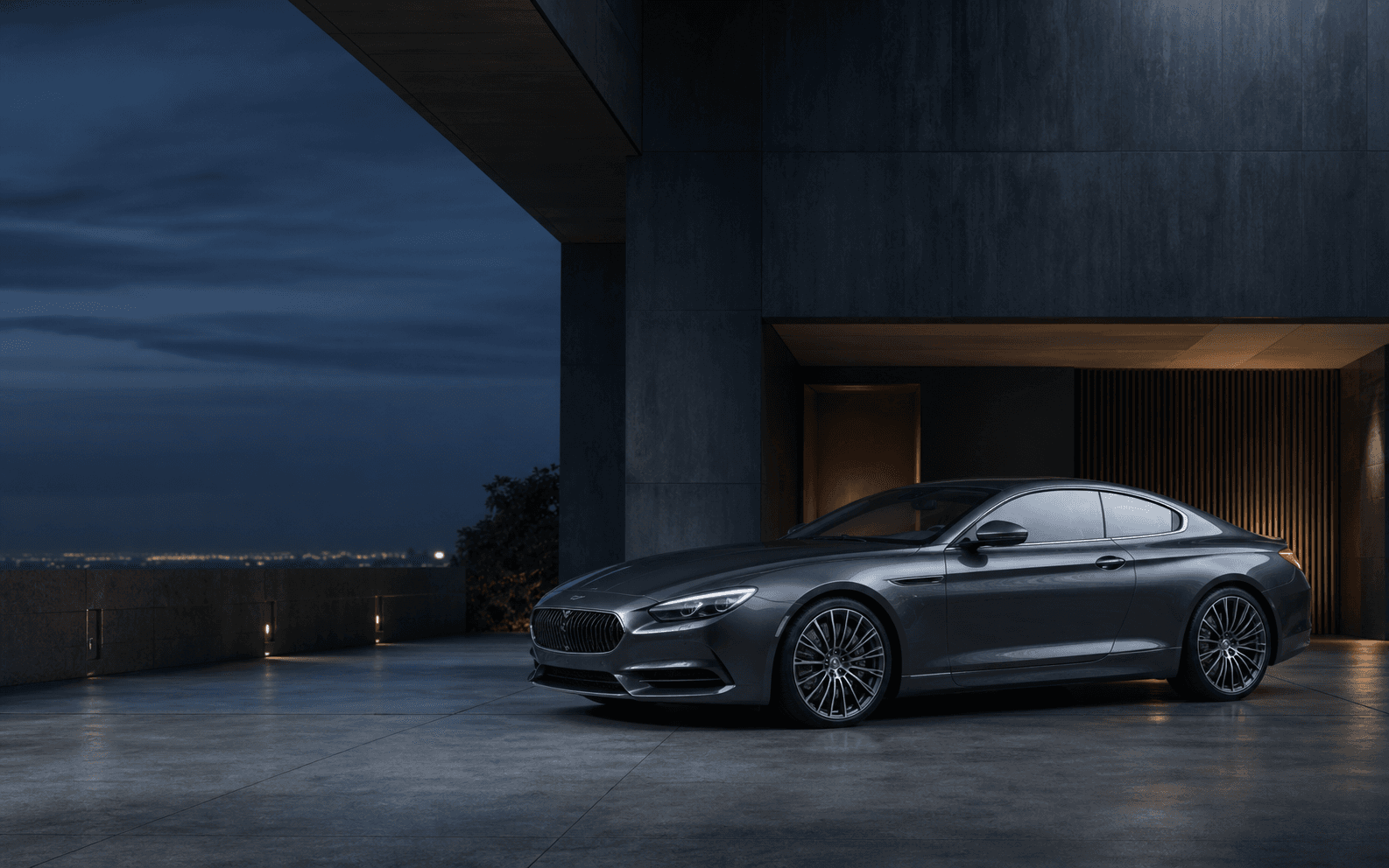 A graphite grand touring car in a private showroom